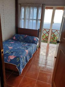 a bedroom with a bed with a view of the ocean at Finca Agua Viva in Viotá