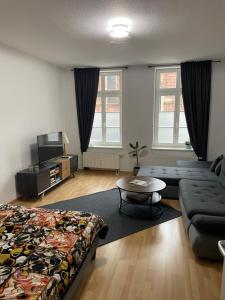 a living room with a bed and a couch at Unterkunft direkt an der Schelfkirche in Schwerin