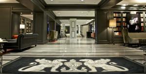 a lobby with a library with a drawing of horses on the floor at Melrose Georgetown Hotel in Washington, D.C.
