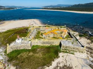 an aerial view of a house on a island in the ocean at Olá Vida - Hostel Caminha in Caminha