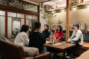 a group of people sitting around a table in a restaurant at tabi-shiro in Matsumoto
