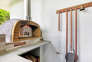 a kitchen with a brick oven in a room at Ohana- Ultimate family escape in Kewarra Beach