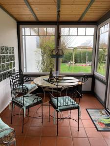 a screened in porch with a table and chairs at Huus Mövchen in Borkum
