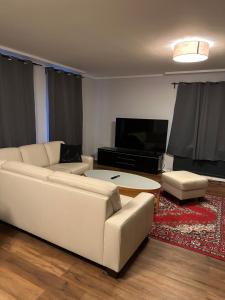 a living room with a white couch and a table at Apartment Hamburg Süd in Hamburg
