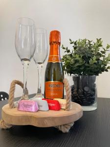 - une bouteille de champagne et 2 verres à vin sur une table dans l'établissement Garden House Cit Turin, à Turin