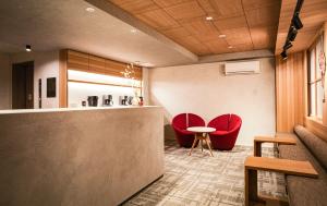 a lobby with two red chairs and a table at Miru Kyoto Gion in Kyoto