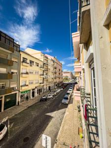 a city street with cars parked on the side of a building at Fortune Guest house in Lisbon