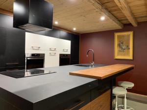 a kitchen with a counter with a sink and a stove at paradis blanc in Orelle