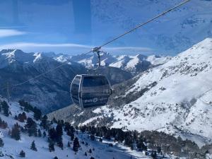 a ski lift flying over a snow covered mountain at paradis blanc in Orelle