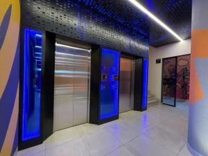 a lobby with blue elevators in a building at SPACE BOX in Cochabamba