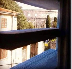 a view from a window of a building at Colloseum View from the apartment in Pula