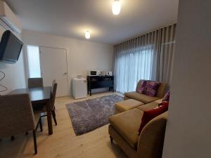 a living room with a couch a table and a dining room at bamboo in Apollo Bay