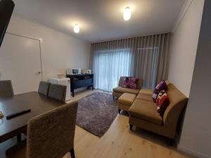a living room with a couch and a table and chairs at bamboo in Apollo Bay