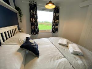 Voodi või voodid majutusasutuse East Coast Chalets 333 Sunny Corner at California Sands toas +44 fotot