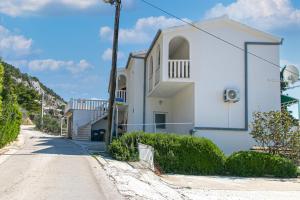 a white house on the side of a road at Apartment Pisak 5975d in Pisak