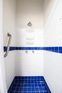 a bathroom with a blue and white tiled tub at Caribbean Backyard - Home w Private Pool/Jacuzzi in Aguada