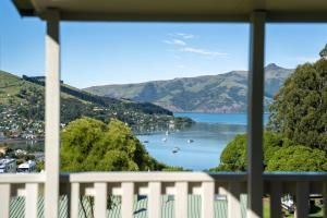 a view of a lake from a balcony at Akaroa Top 10 Holiday Park in Akaroa