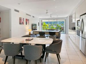 een keuken en eetkamer met een tafel en stoelen bij Blue on Blue Apartment 317 in Nelly Bay