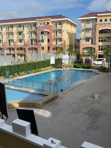 a swimming pool in front of some apartment buildings at Allen’s cozy condo in Davao City
