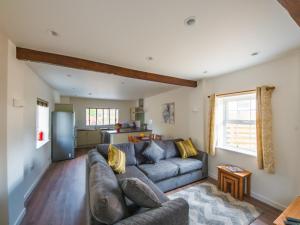 a living room with a couch and a kitchen at Fir Cottage - Uk38485 in Saltash