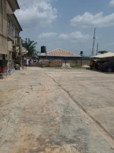 an empty parking lot in front of a building at Grace apartment in Ofatedo