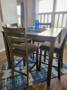 a dining room table with two chairs and a laptop on it at Convenient and Comfortable in Macon