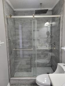 a shower with a glass door in a bathroom at Convenient and Comfortable in Macon