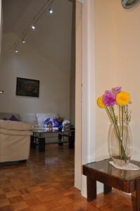 a living room with a vase of flowers on a table at Apartment Sea San in Makarska