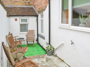 a patio with two chairs and a table at Hulne House in Alnwick