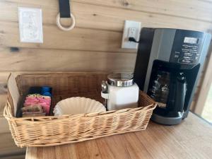 a basket sitting on top of a counter with a coffee maker at Bourbon Barrel Cottages #1 of 5 on Kentucky trail in Lawrenceburg