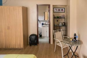a living room with a table and chairs and a kitchen at JW Apartments in Angeles