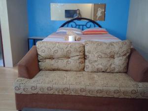 a bed with a couch in a room at JW Apartments in Angeles