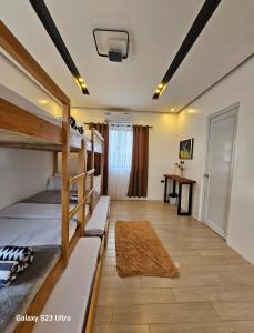 a room with bunk beds in a hostel at Obra Maestro Private Resort in Lubao