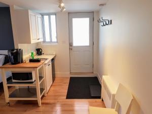 a small kitchen with a sink and a microwave at Bright and Spacious Studio Apartment in Montreal