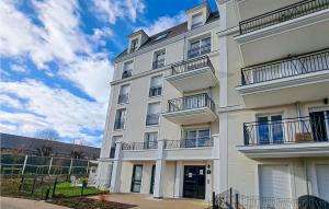 a white building with balconies on the side of it at Stunning Apartment In Le Blanc-mesnil With Kitchen in Le Blanc-Mesnil
