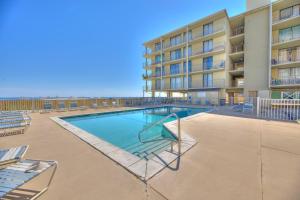a swimming pool in front of a building at Living the Dream 2 Bedroom Ocean View Cozy Condo in Gulf Shores