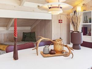 a table with a vase and other items on it at 4 person holiday home in Hjørring in Hjørring