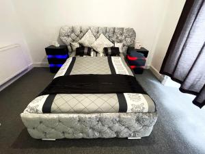 a bedroom with a bed and a couch in it at Spacious 3 Bedroom Entire Apartment Self Check in in Fife