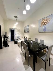 a living room with a dining table and a couch at Lafayette Park Square Condominium Megaworld in Iloilo City