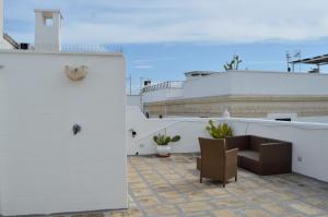 a balcony with a table and chairs on a building at Suite Dolce Vita in Monopoli