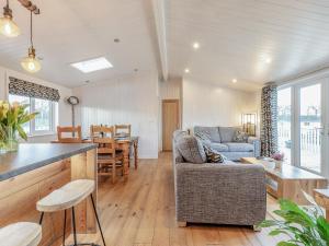 a living room with a couch and a table at Heather Lodge in Willington