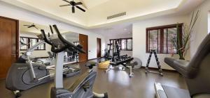 a gym with several treadmills and cardio machines at Baan Tao Talay - by Sublime Samui Villas in Lipa Noi