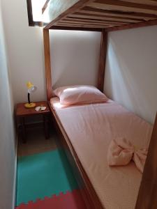 a small bedroom with a bunk bed and a table at Butterfly in Tajo Alto