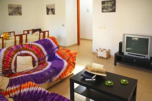 a living room with a couch and a tv at House in S'Illot near Sandy Beach in S'Illot