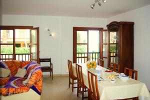 a living room with a table and a couch at House in S'Illot near Sandy Beach in S'Illot +17 photos
