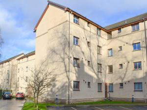 a large building with a large shadow on the side of it at Queens Hill in Edinburgh