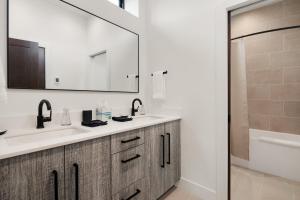 a bathroom with a sink and a mirror and a tub at Barrel Ridge at Suncadia in Cle Elum +87 photos