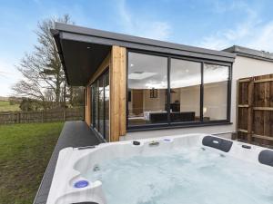 a hot tub in the backyard of a house at The Bunker - Uk40225 in Bardon Mill
