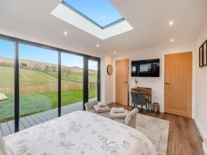 a bedroom with a large skylight in a house at The Bunker - Uk40225 in Bardon Mill