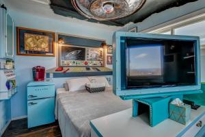 a living room with a large tv in a room at The Oasis on Eisenhower in Loveland